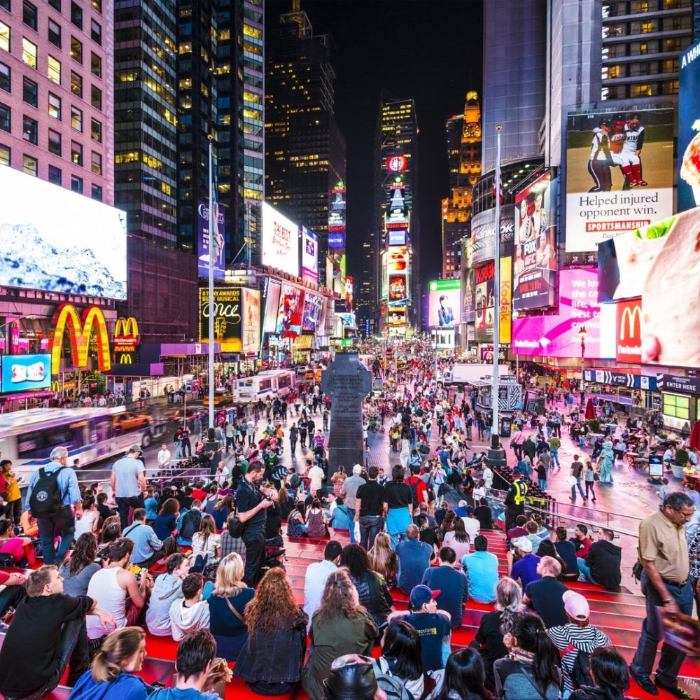 NEW YORK, NEW YORK - APRIL 9, 2013: Times Square crowds at night in Midtown Manhattan. The site is regarded as the world's most visited tourist attraction with nearly 40 million visitors annually.